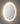 Oval shaped frame less backlit mirror.