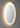 Oval shaped frame less back lit mirror.